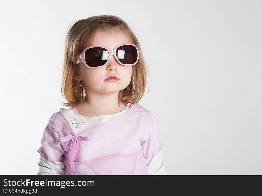 Little girl in sunglasses studio photo