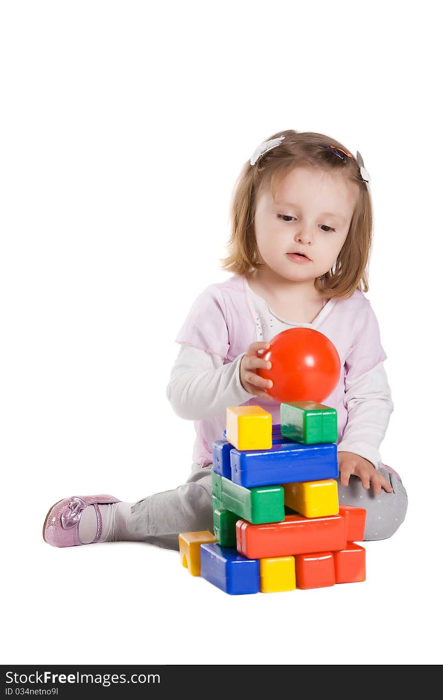 Little girl playing with cubes isolated