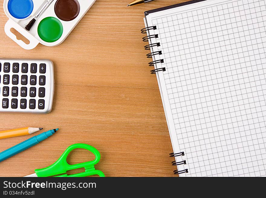 School Accessories And Checked Notebook On Wood