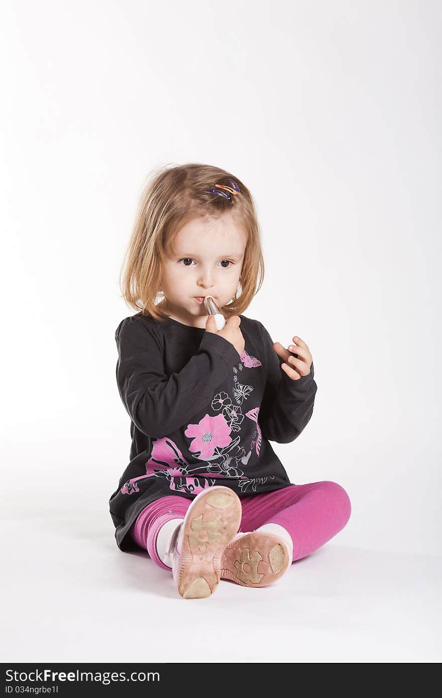 Little girl with lipstick