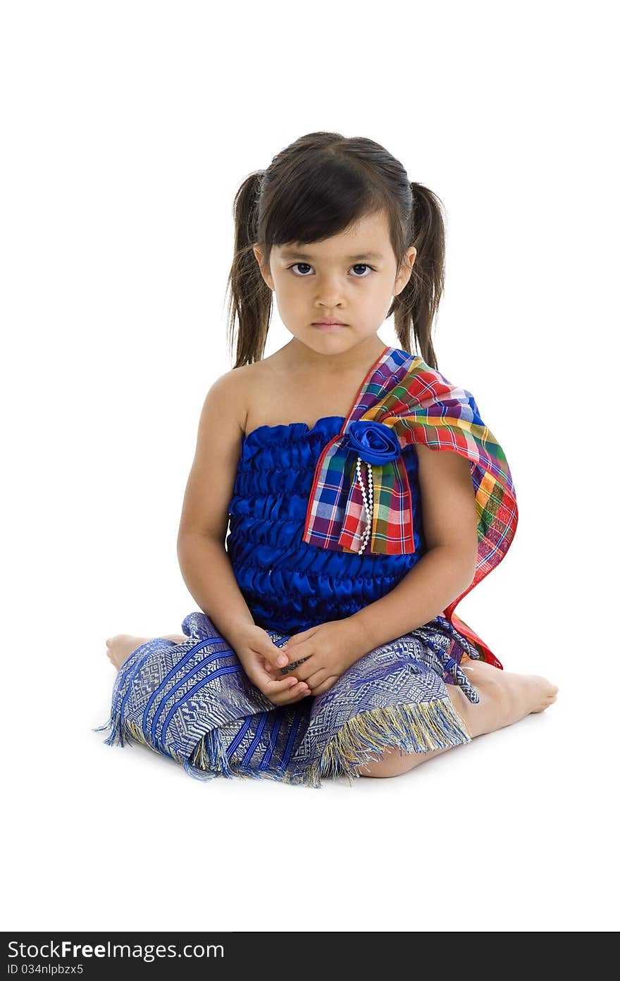 Cute little girl in traditional thai clothes isolated on white background