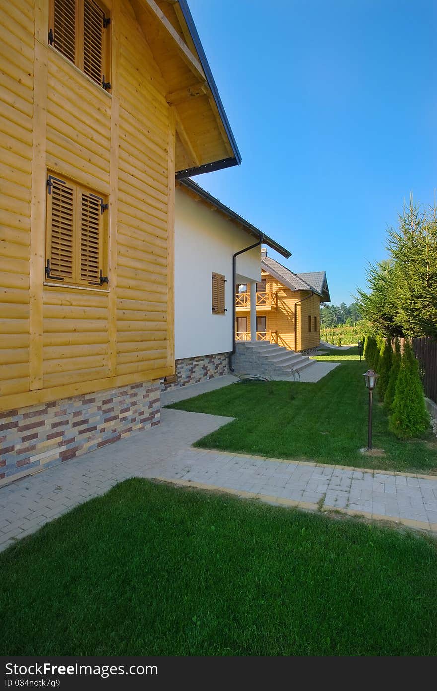 New empty house, backyard perspective. Modern and traditional styles mixed. Apartments on sale.