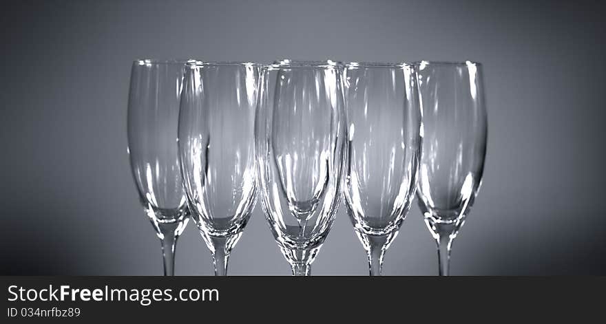 Empty champagne glasses on gray background