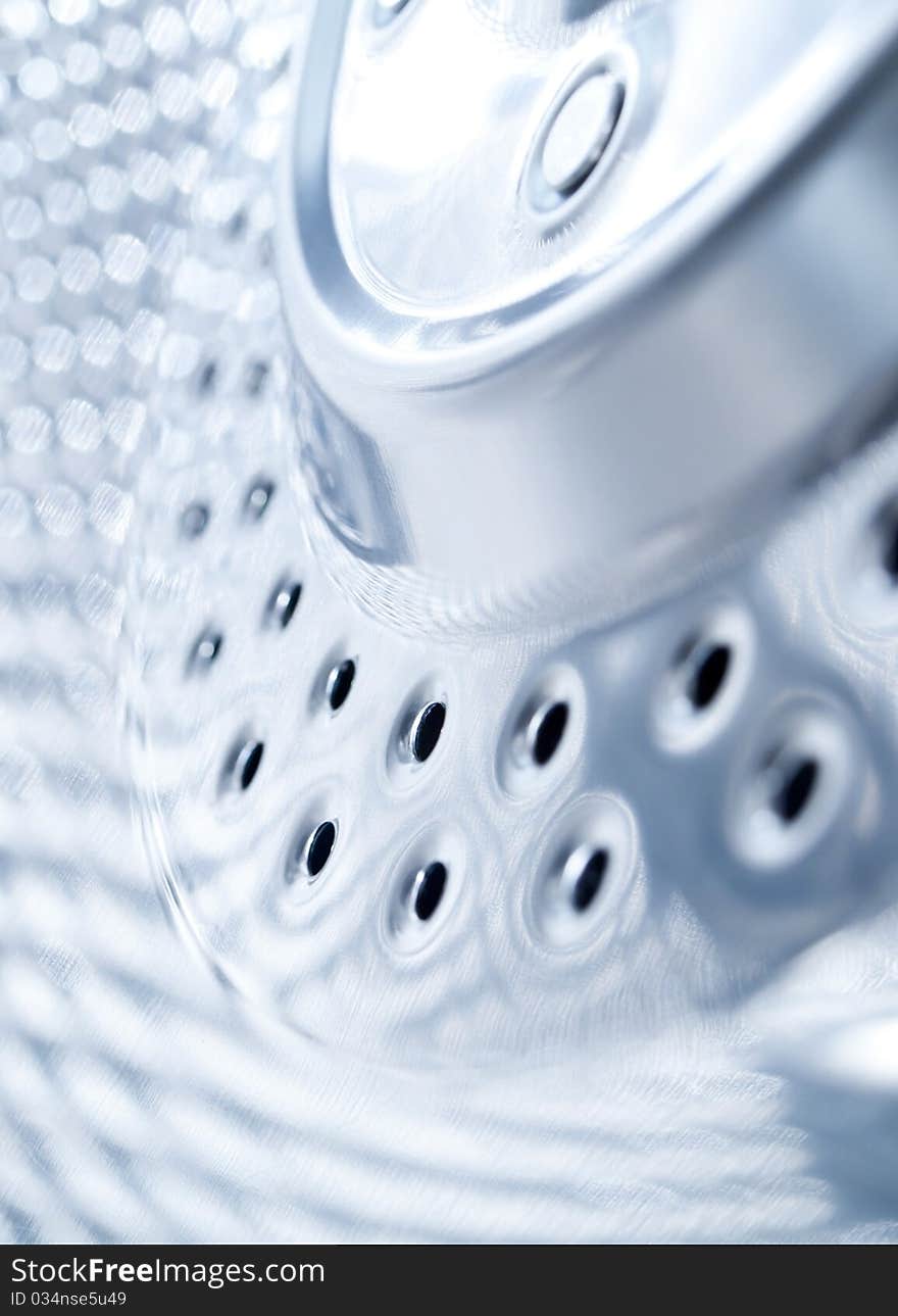 Close- up of stainless steel drum inside a washing machine. Close- up of stainless steel drum inside a washing machine