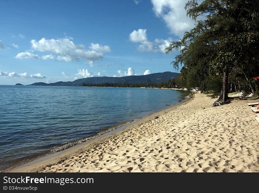 View of a tropical beach with mountains , image was taken in Thailand