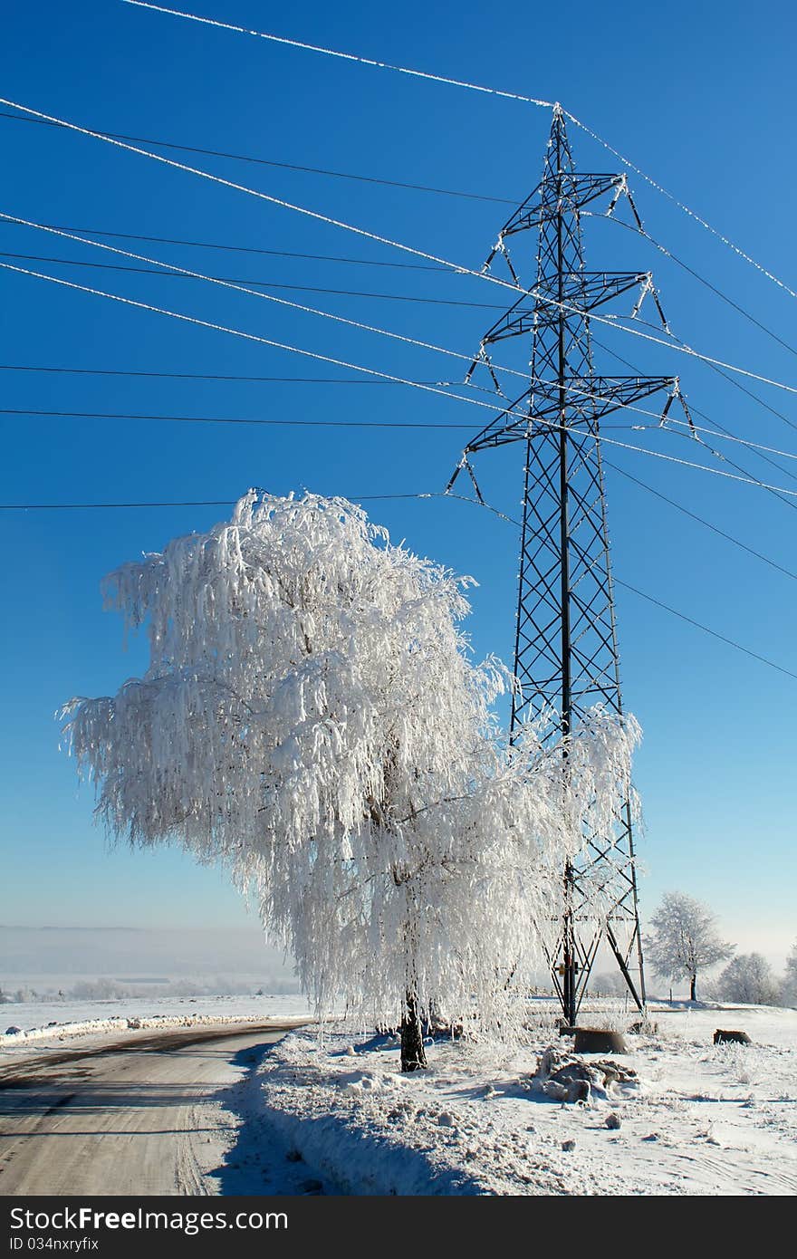 Winter road on a sunny frosty day with blue sky