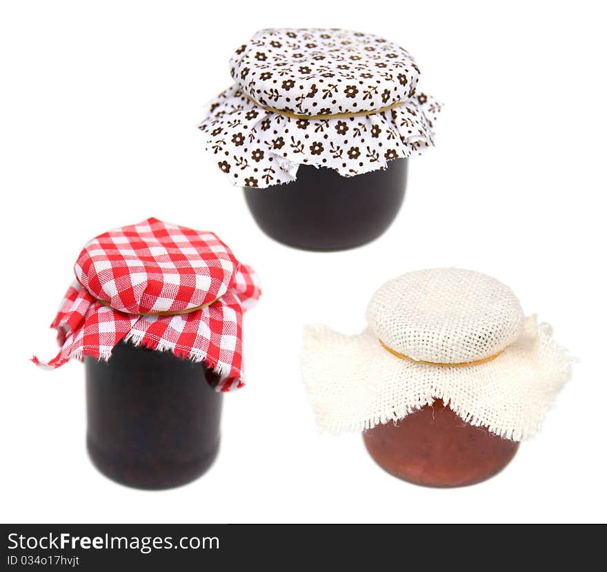 Three different jars covered with cloth isolated over white