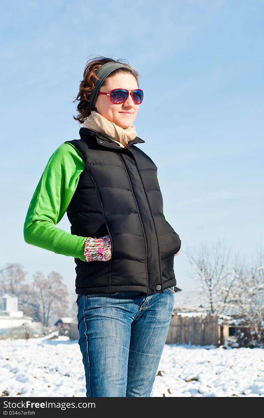 Young woman with red sunglasse in an outdoor winter setting. Young woman with red sunglasse in an outdoor winter setting