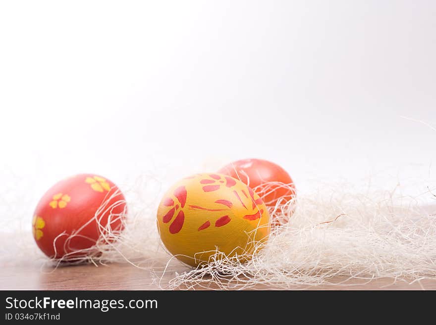 Hand painted colored Easter eggs in hay. Hand painted colored Easter eggs in hay.