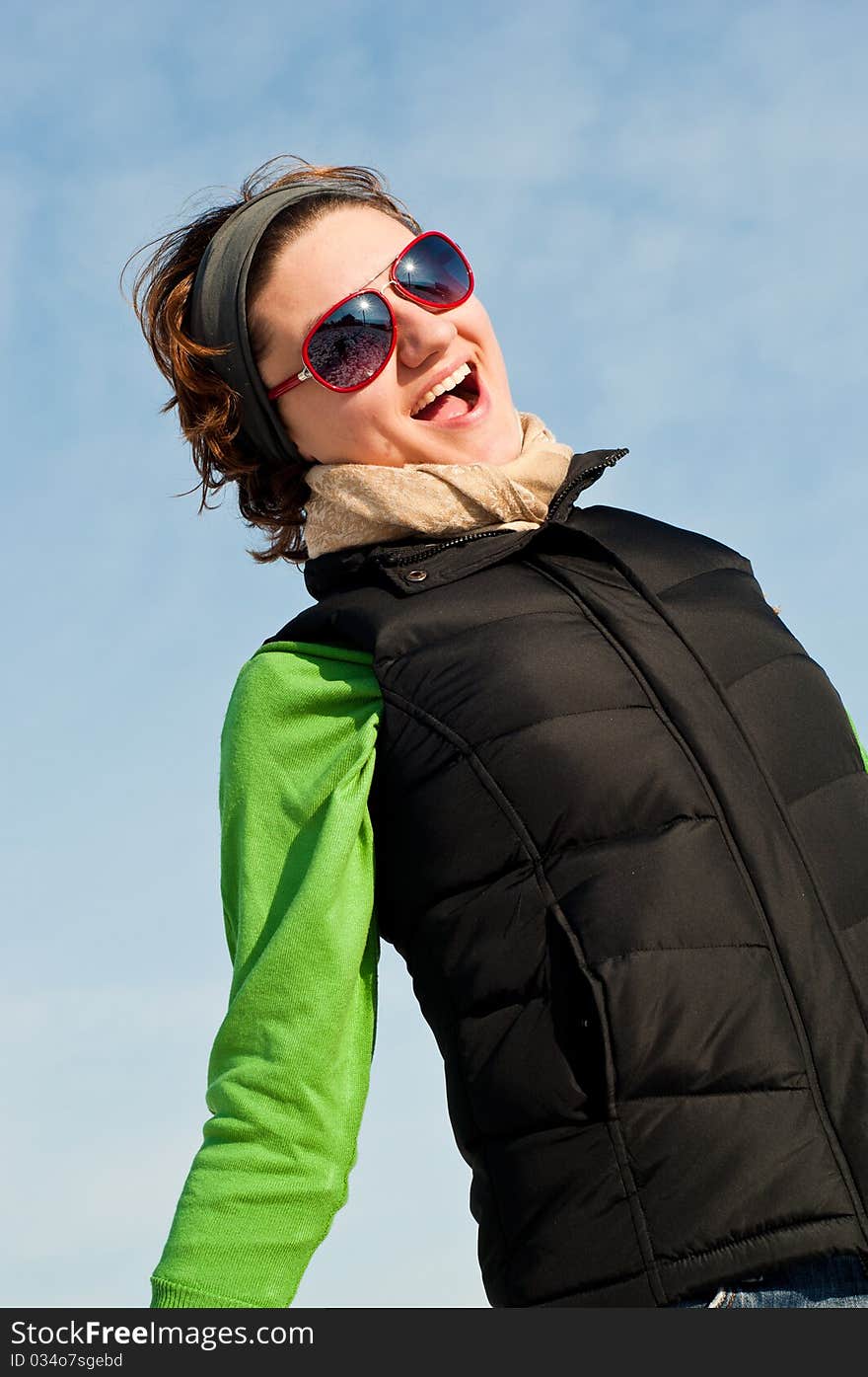 Young woman with red sunglasse in an outdoor winter setting. Young woman with red sunglasse in an outdoor winter setting