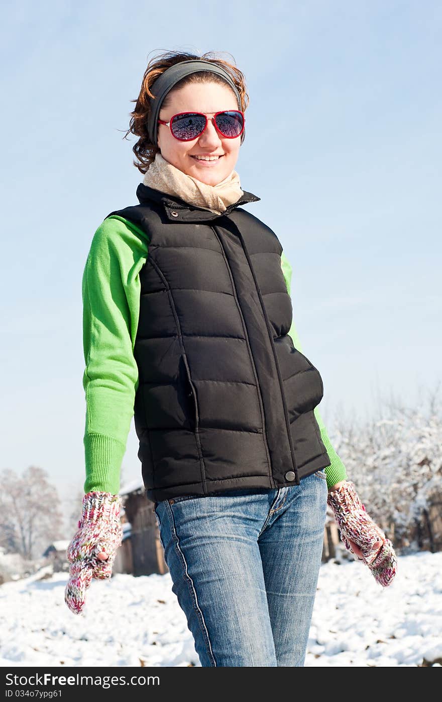 Young woman with red sunglasse in an outdoor winter setting. Young woman with red sunglasse in an outdoor winter setting