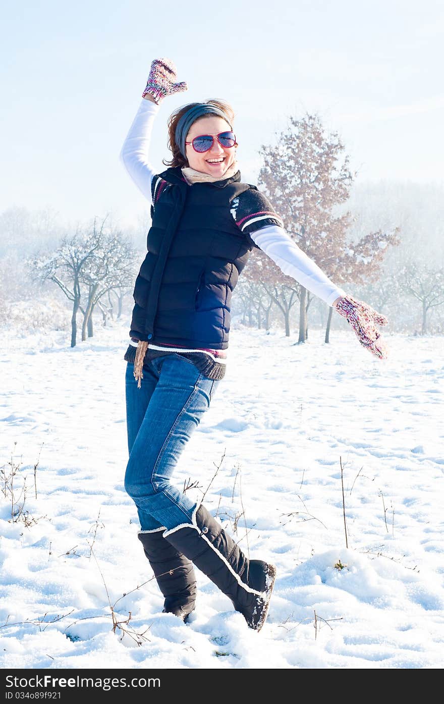 Young woman with red sunglasse in an outdoor winter setting. Young woman with red sunglasse in an outdoor winter setting