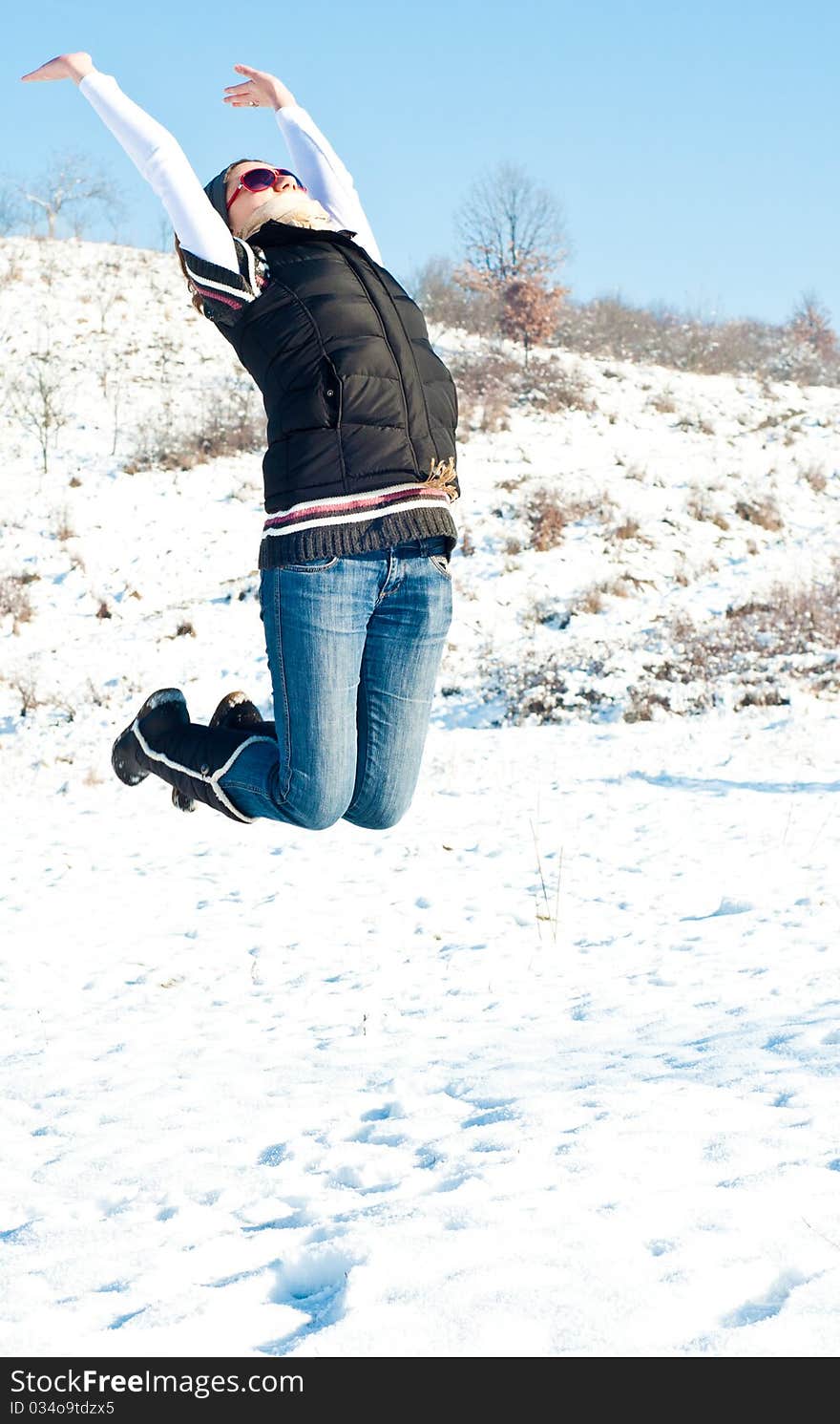 Young woman jumping of joy in a winter setting