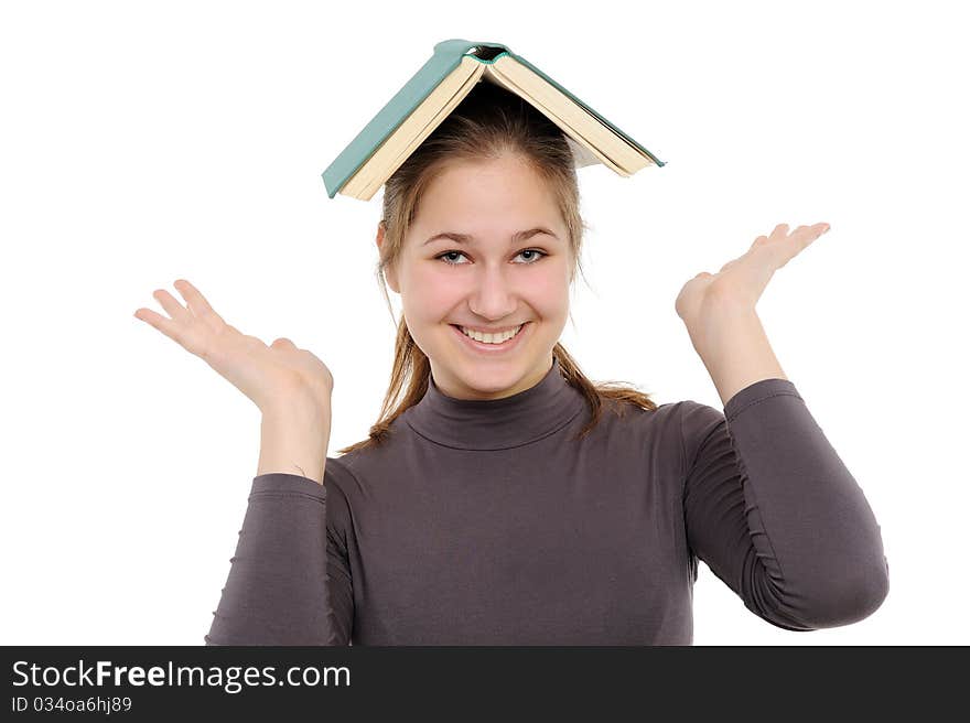 Girl with thick and heavy textbook over her head. Girl with thick and heavy textbook over her head