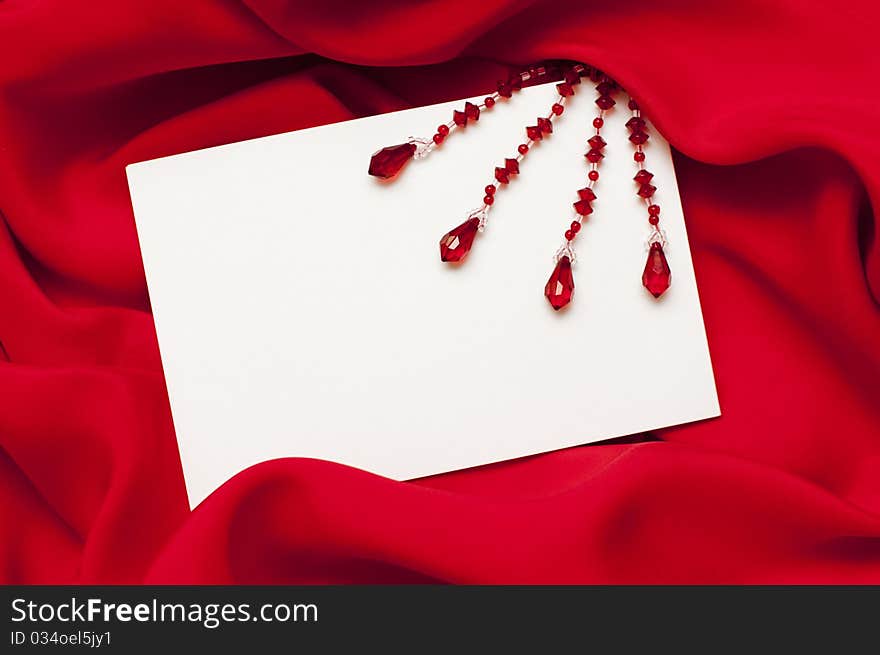 Empty greeting card on red satin background. Empty greeting card on red satin background