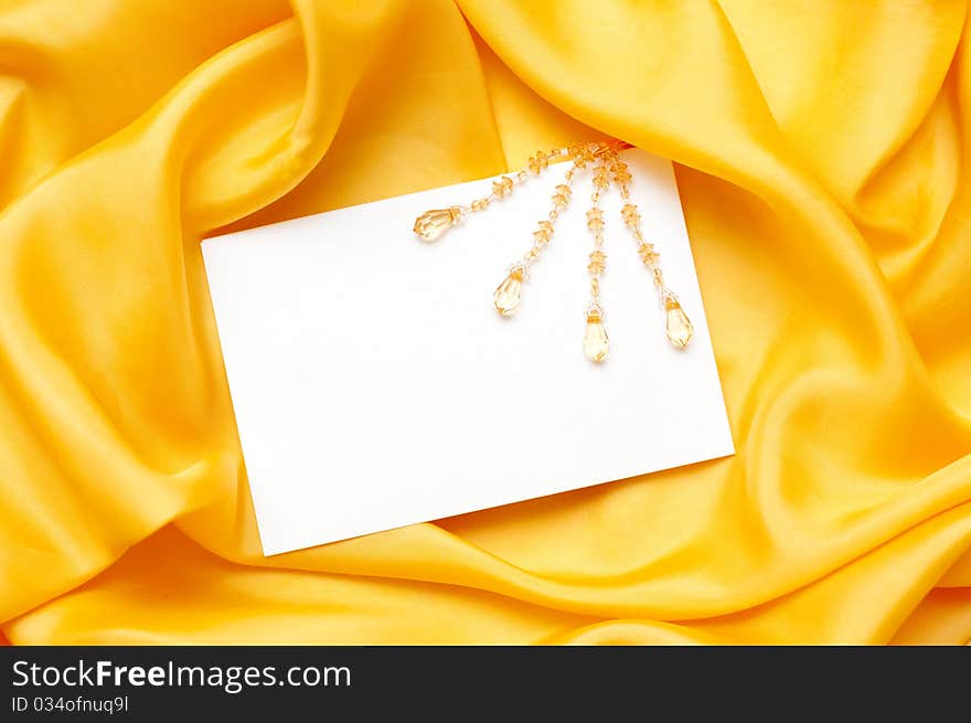 Empty greeting card on yellow satin background. Empty greeting card on yellow satin background