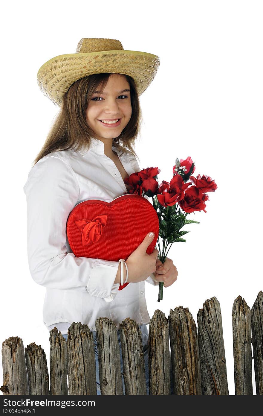 A beautiful young teen delighted with a heart-shaped box of chocolates and red roses. Isolated on white. A beautiful young teen delighted with a heart-shaped box of chocolates and red roses. Isolated on white.