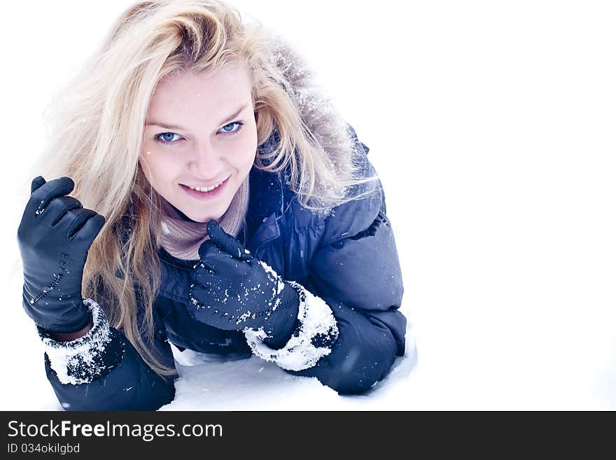 Cute young blonde on snowdrift