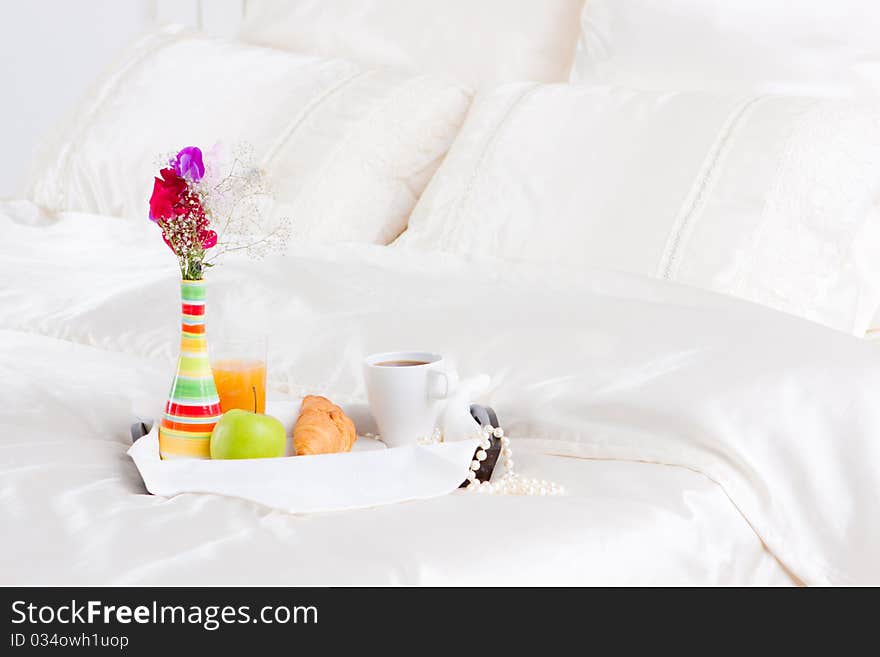 Cup of coffe and flower in vase on tray. Cup of coffe and flower in vase on tray