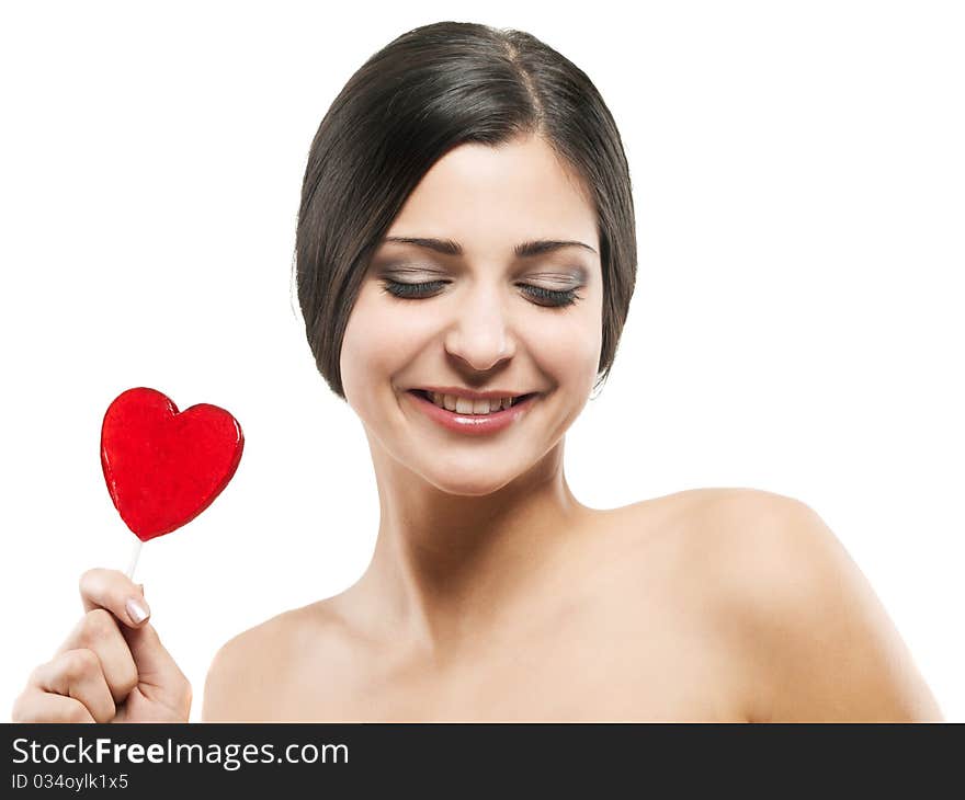 Closeup shot of girl with red heart lolipop isolated on white