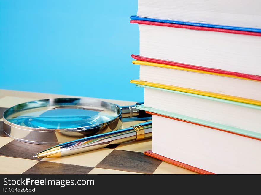 School accessories and checked notebook on wood