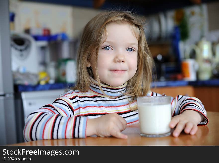 An image of a girl with a glass of milk