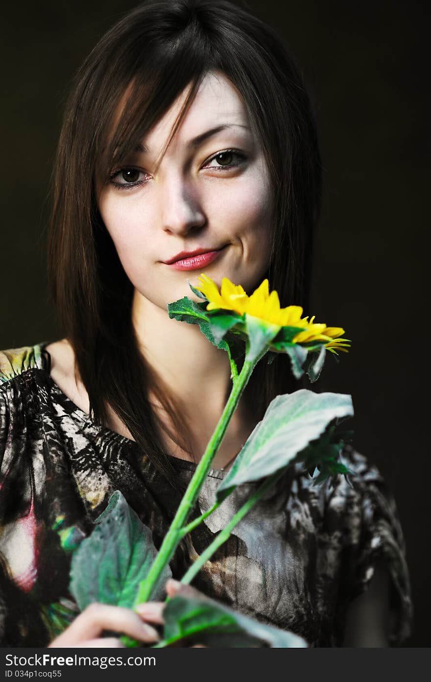 A beautiful woman with sunflower in her hand. A beautiful woman with sunflower in her hand