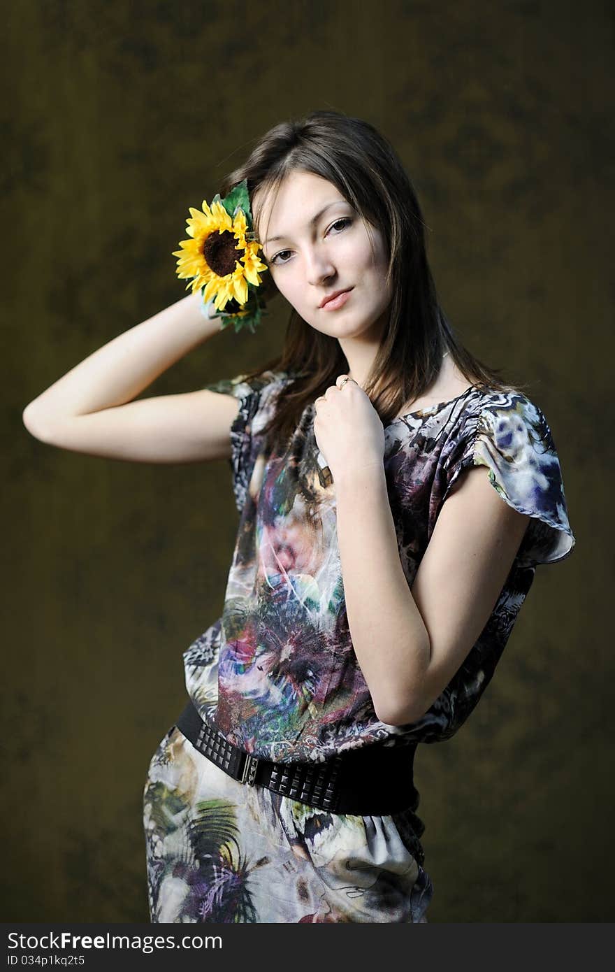 A beautiful woman with a sunflower in her hair. A beautiful woman with a sunflower in her hair