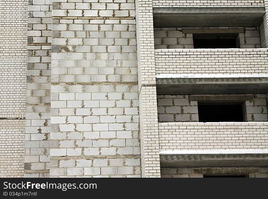 Wall under construction of bricks and building blocks (gray color, only bricks and blocks without plaster and other processing). Wall under construction of bricks and building blocks (gray color, only bricks and blocks without plaster and other processing)