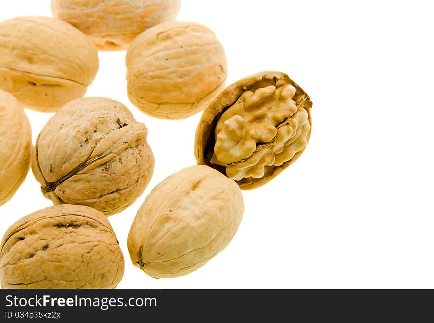 Some walnuts, one of which are split (On a white background)