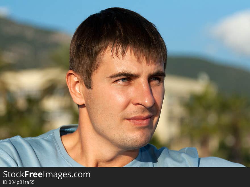 Portrait of a man against the backdrop of greenery