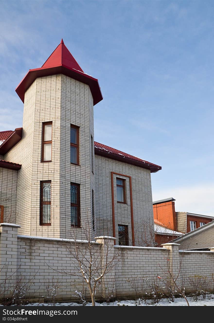 Urban house with red roof in the form of turrets. Urban house with red roof in the form of turrets