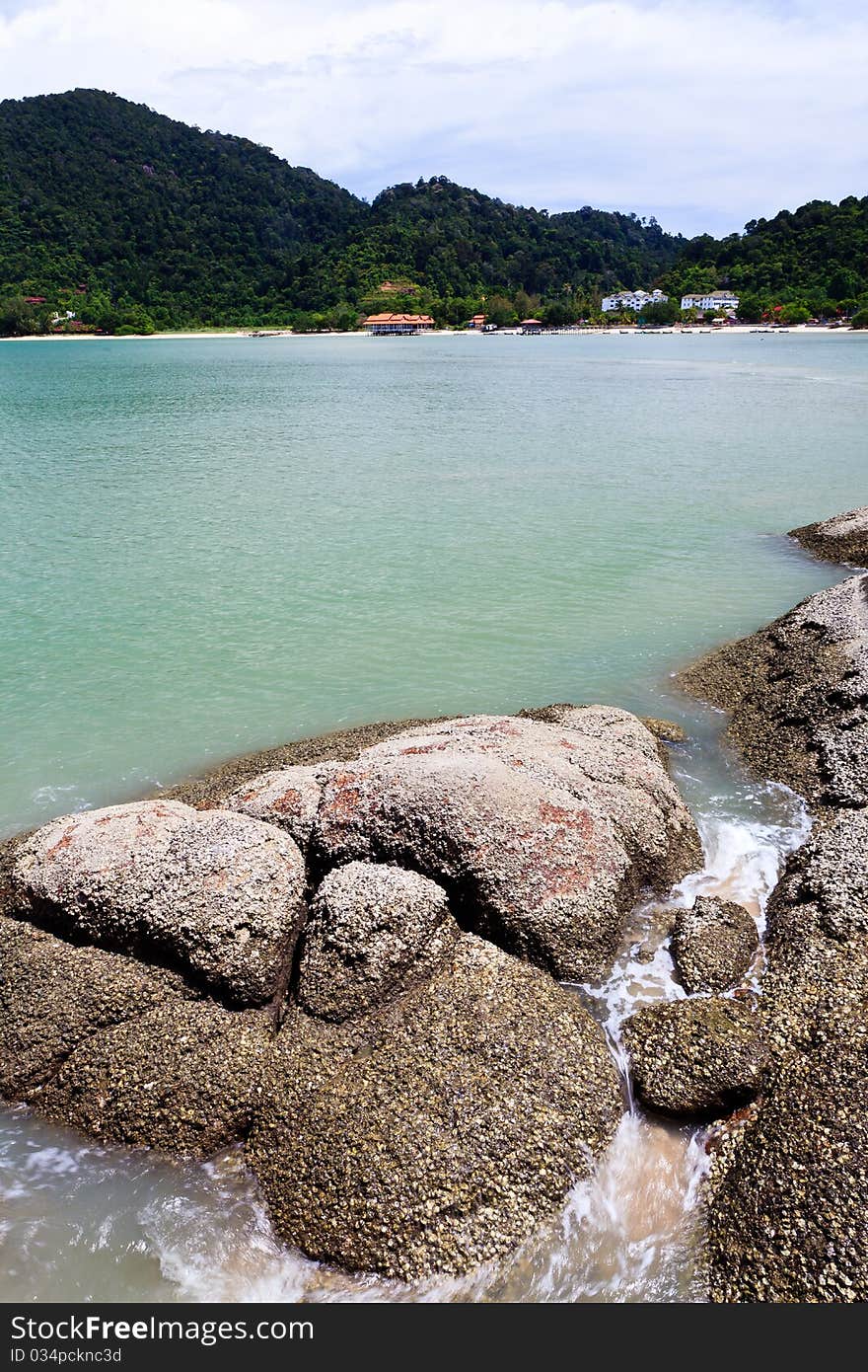 Tropical rocky beach with rain forest in Malaysia