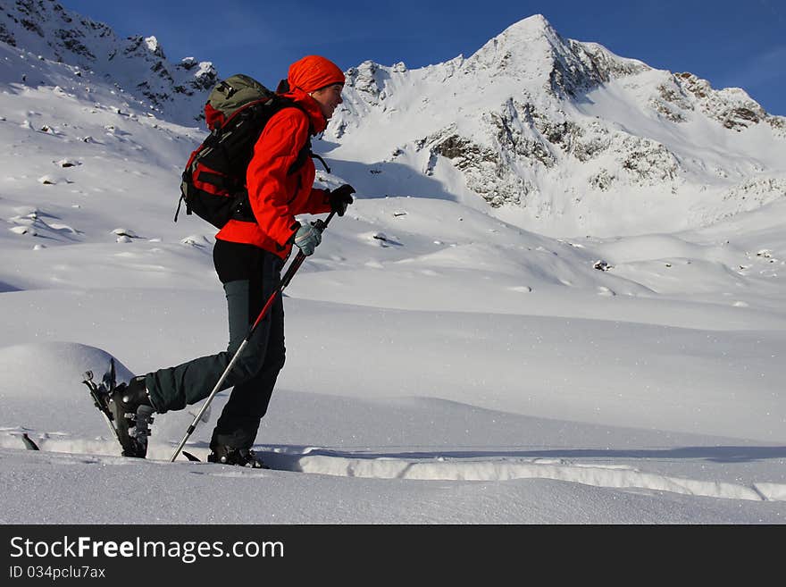 Young woman doing ski touring. Outdoor winter activity