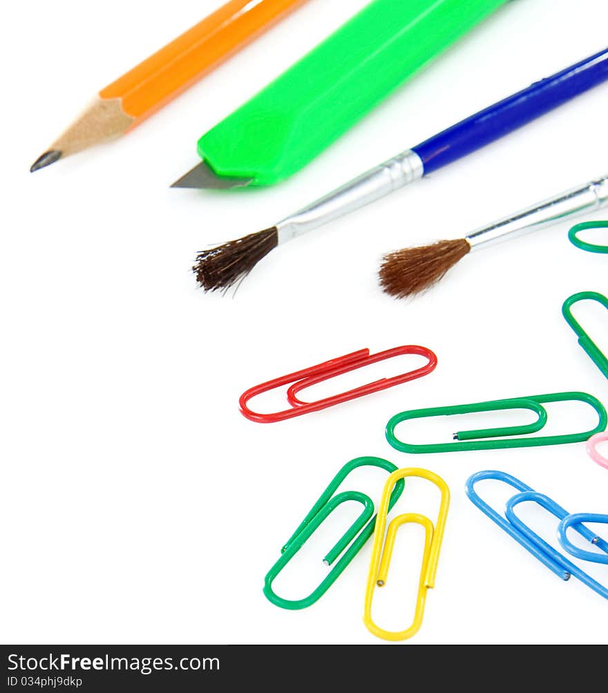 Paintbrush, paper clips and pencil isolated on white background. Paintbrush, paper clips and pencil isolated on white background