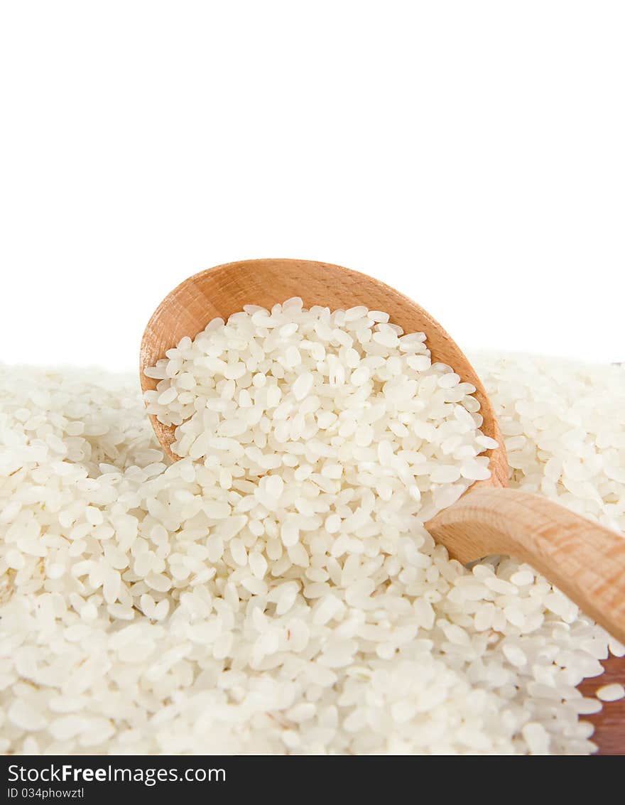 Rice grain in wooden spoon isolated on white background