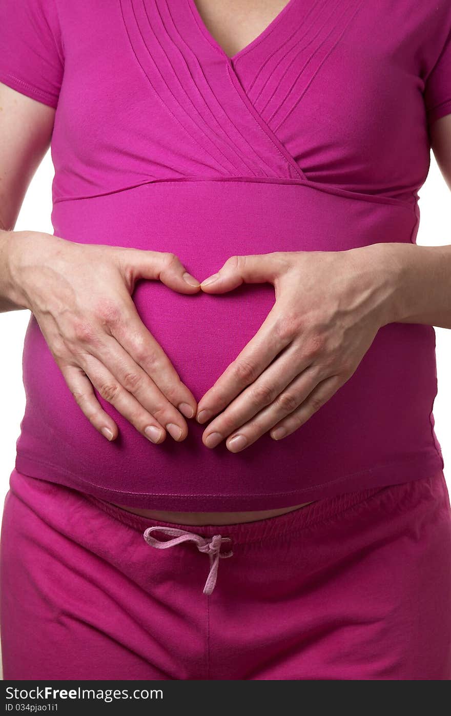 Pregnant woman profile with heart shape hands on the stomach over white background. Pregnant woman profile with heart shape hands on the stomach over white background