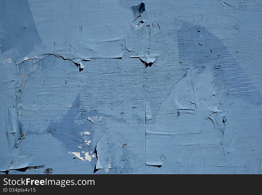 Blue wooden wall with pieces of paper. Blue wooden wall with pieces of paper