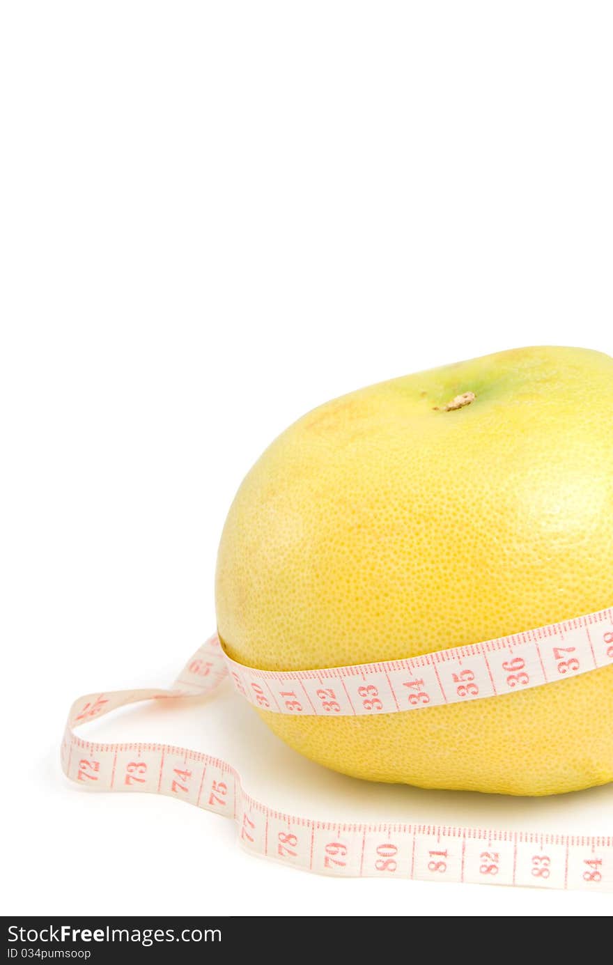 Grapefruit in the measuring tape, is isolated on a white background. Grapefruit in the measuring tape, is isolated on a white background