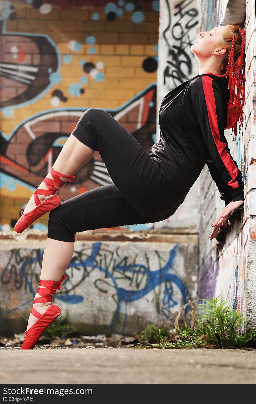 Young ballet dancer posing in factory zone