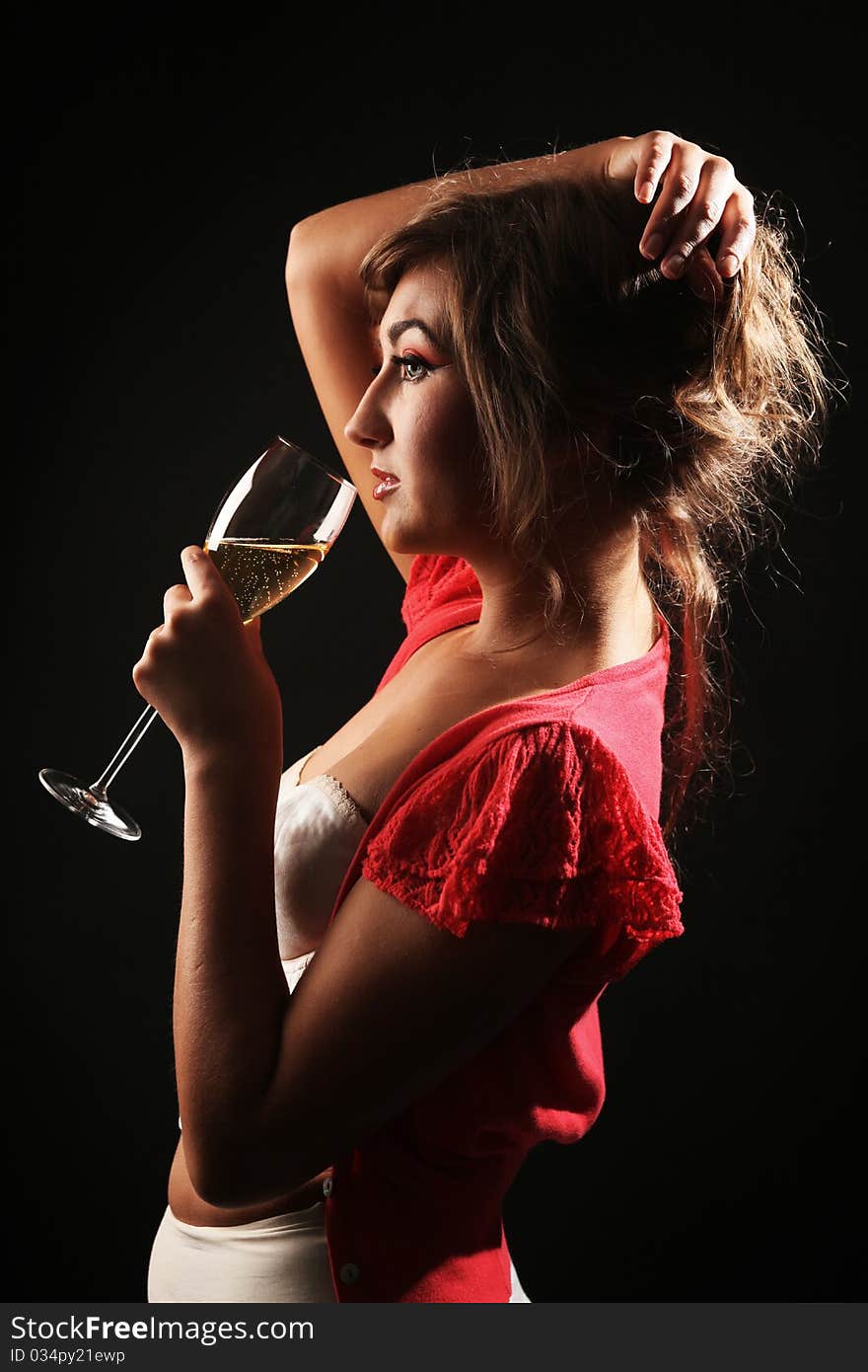 Beautiful woman with glass of champagne in studio