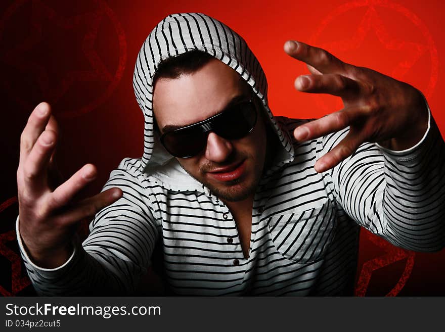 Young clubber in hoody with sunglasses on his eyes. Young clubber in hoody with sunglasses on his eyes