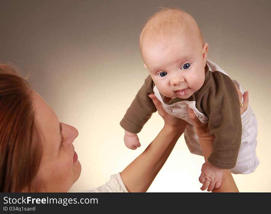 Young mother holding her beautiful child. Young mother holding her beautiful child