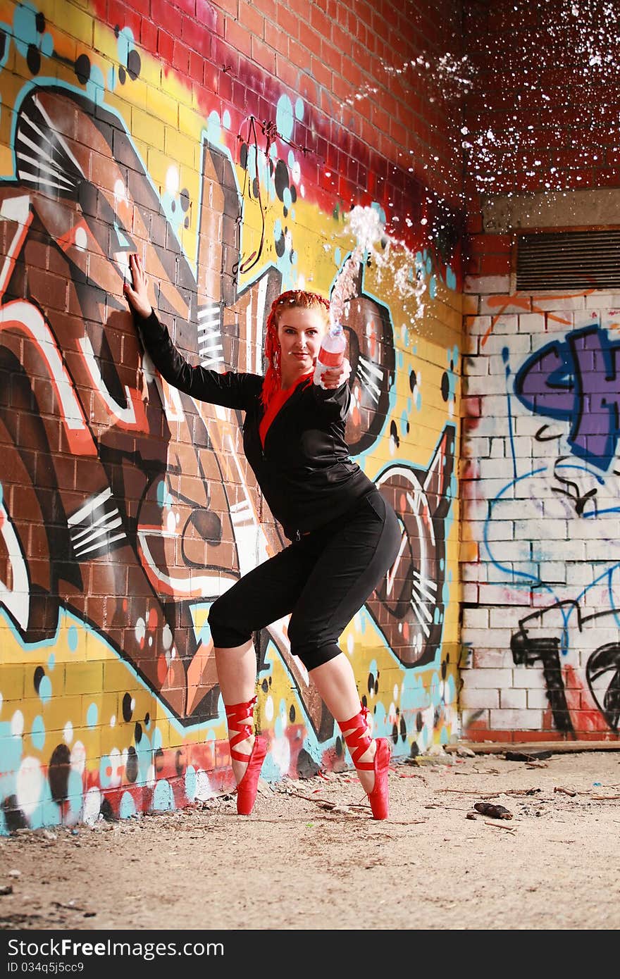 Urban ballet dancer splashing water