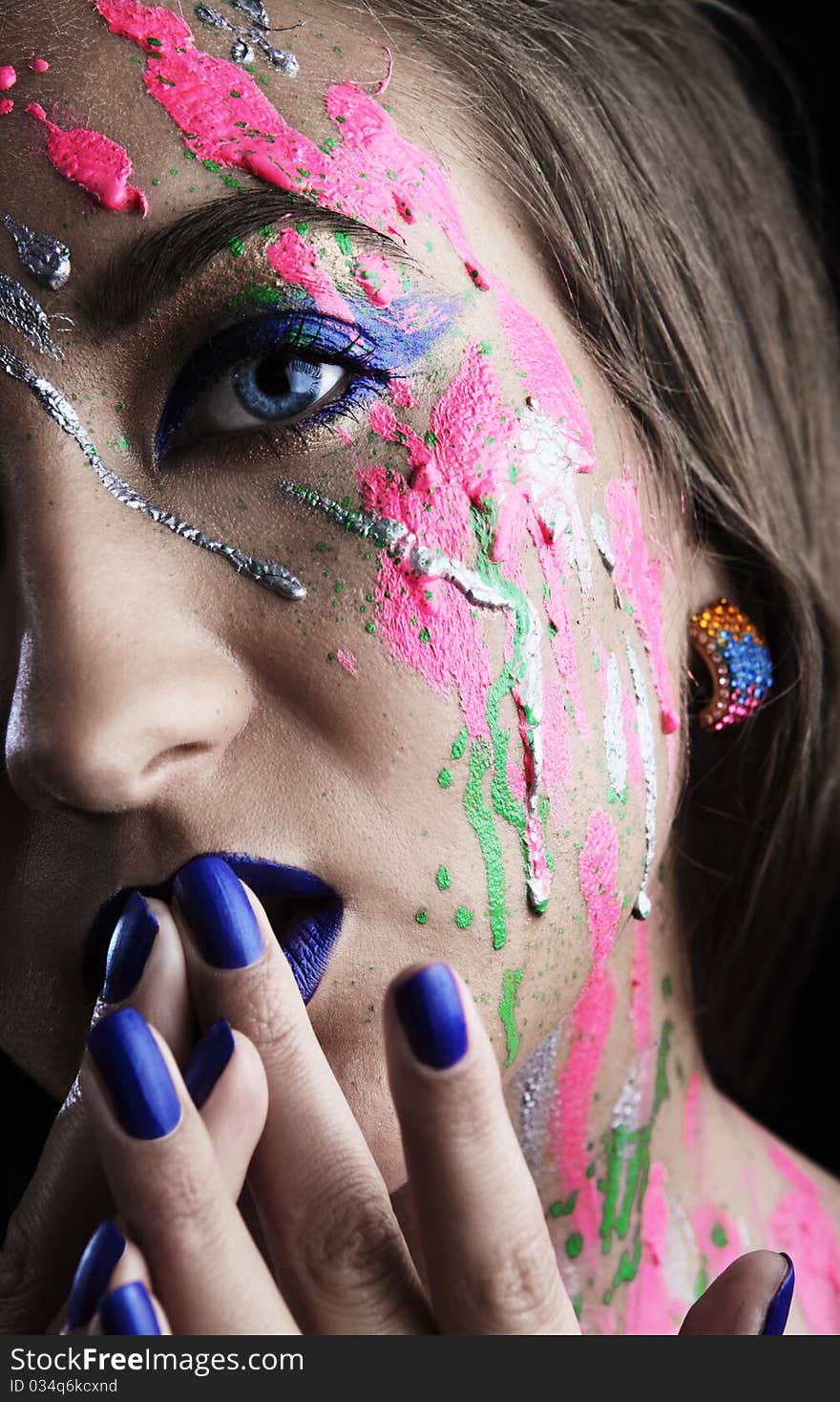 Close-up of woman with colored paint on face