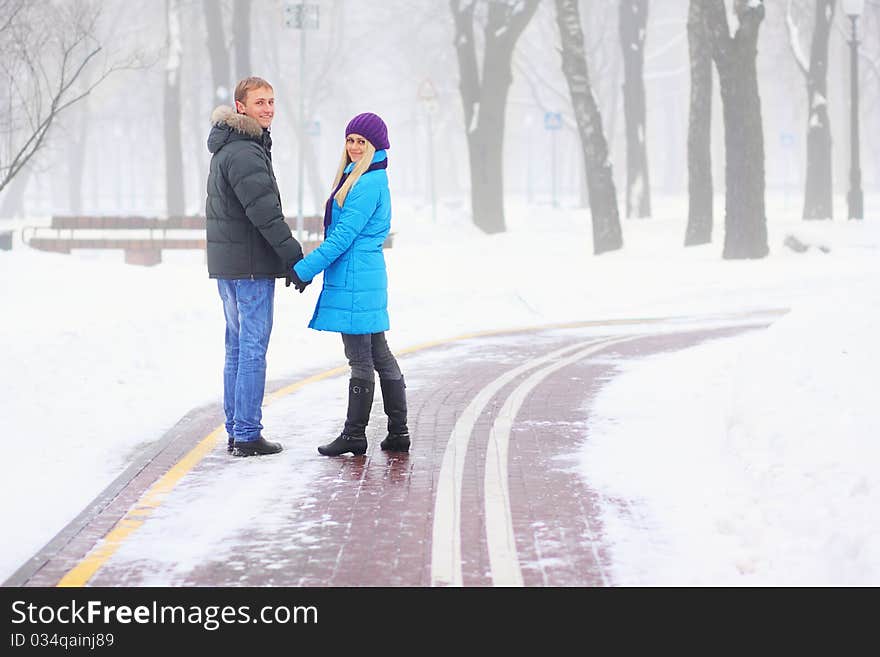 Young adult couple in the park. Winter.