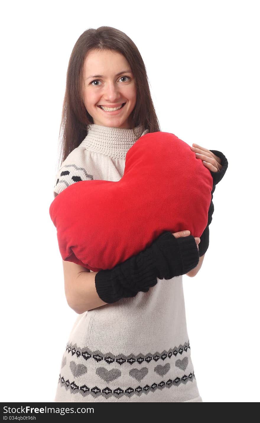 Happy fashionable young woman holding red Valentine's heart and smiling; isolated on white. Happy fashionable young woman holding red Valentine's heart and smiling; isolated on white