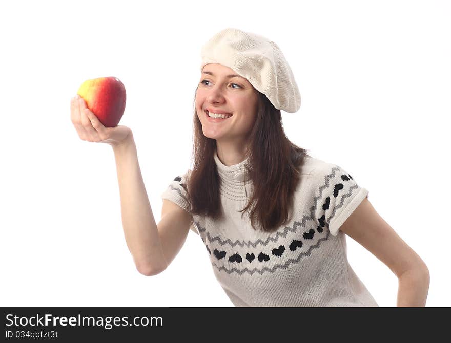 Happy young woman looking at juicy red apple