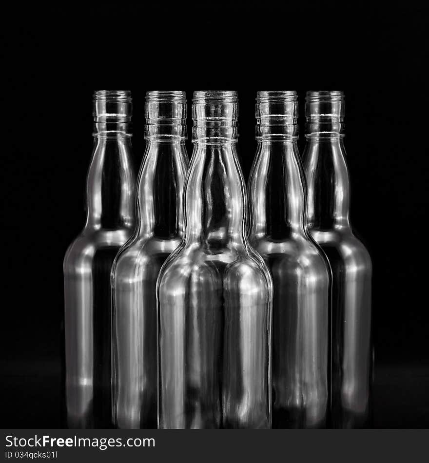 Empty bottles collection, colorless, isolated on black backgrounde