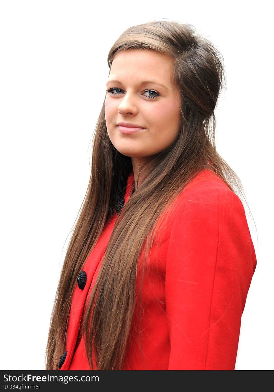 Pretty teenager wearing a red coat on white